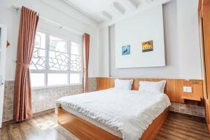 Postel nebo postele na pokoji v ubytování Thanh Anh 2 Hotel - Gần Chợ Đêm Đà Lạt