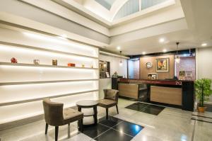 a lobby with two chairs and a table at Civic Park in Bangkok
