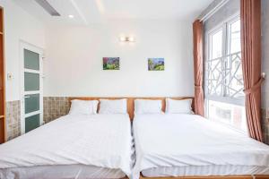 Postel nebo postele na pokoji v ubytování Thanh Anh 2 Hotel - Gần Chợ Đêm Đà Lạt