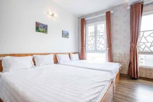 Postel nebo postele na pokoji v ubytování Thanh Anh 2 Hotel - Gần Chợ Đêm Đà Lạt