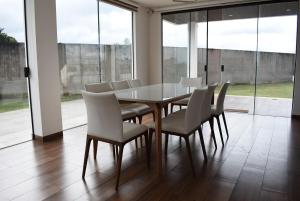 ein Esszimmer mit einem Tisch und weißen Stühlen in der Unterkunft Live the Mar Adentro experience in Santa Cruz de la Sierra