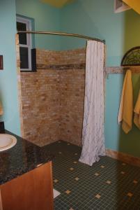 un bagno con tenda da doccia e lavandino di Sierra Trails Inn a Mariposa