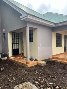 a house is being constructed with a porch and a pole at 'La Maison' 2 bedroom house in Arusha in Arusha