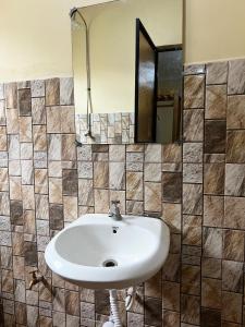 a bathroom with a sink and a mirror at 'La Maison' 2 bedroom house in Arusha in Arusha +17 photos