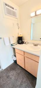 a bathroom with a sink and a mirror at Twin Lakes Inn in Bull Shoals