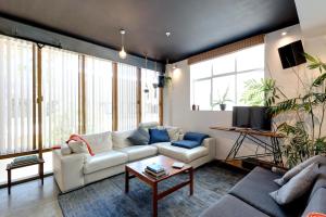 a living room with a couch and a table at Cuba St Apartment & Parking in Wellington