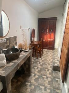 a bathroom with a sink and a wooden table at Lotus & Teak Villas in Dalung +29 photos