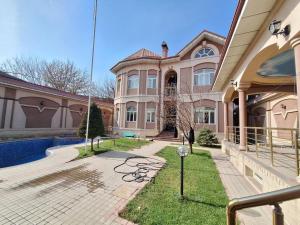a large house with a pool in front of it at MIMFRI PREMIUM guest house, hotel in Tashkent