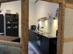 a kitchen with black counters and a counter top at Alte Glaserei Travemünde in Travemünde