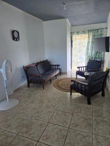 een woonkamer met 2 banken en een ventilator bij Bagatelle Terrace in Saint James