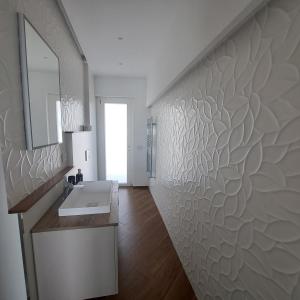 a bathroom with a sink and a wall with a mirror at Casa Marilyn in Agerola +85 photos