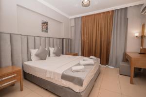 Postel nebo postele na pokoji v ubytování Infinity Hotel
