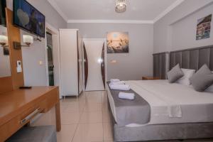 Postel nebo postele na pokoji v ubytování Infinity Hotel