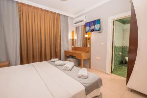 Postel nebo postele na pokoji v ubytování Infinity Hotel