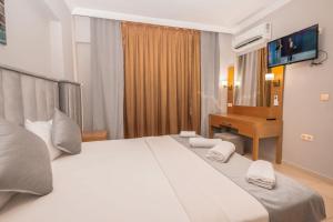 Postel nebo postele na pokoji v ubytování Infinity Hotel