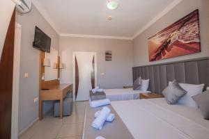 Postel nebo postele na pokoji v ubytování Infinity Hotel
