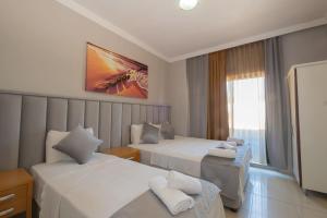 Postel nebo postele na pokoji v ubytování Infinity Hotel