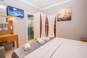 Postel nebo postele na pokoji v ubytování Infinity Hotel + 29 fotografií