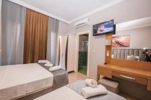 Postel nebo postele na pokoji v ubytování Infinity Hotel