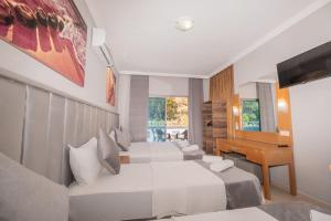 Postel nebo postele na pokoji v ubytování Infinity Hotel