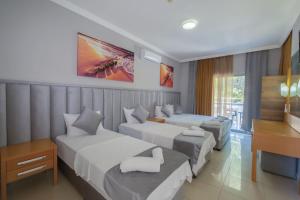 Postel nebo postele na pokoji v ubytování Infinity Hotel