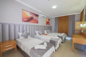 Postel nebo postele na pokoji v ubytování Infinity Hotel
