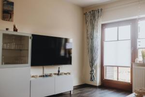 a living room with a flat screen tv on a wall at Küsten Auszeit in Wremen
