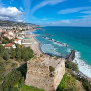 an aerial view of a beach with an old castle at angi home in Arma di Taggia