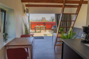 a living room with a table and chairs at Stenhuset in Oxie