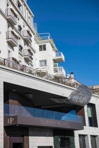 a white building with a sign in front of it at Europa Palace in Sanremo