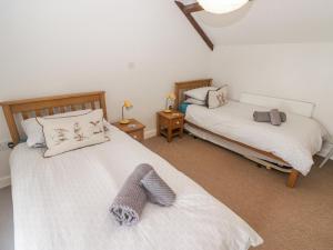 a bedroom with two beds and two night stands at Florida Cottage in Swansea