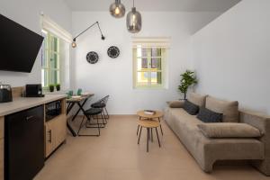 a living room with a couch and a table at Agkyra Studio in Symi