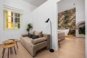 a living room with a couch and a table at Agkyra Studio in Symi +9 photos