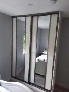 a bathroom with a mirror on the wall at Elsie's Sea View Lodge Lahinch in Rineen