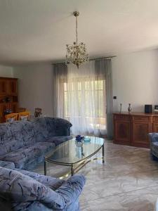 a living room with a couch and a glass table at Vintage villa in Paleo Tsifliki