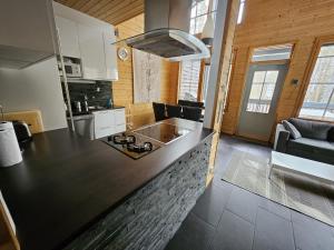 a kitchen with a black counter top in a room at Levi Happi in Kittilä