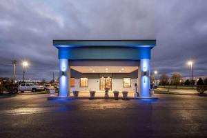 a gas station with a blue building in a parking lot at Baymont by Wyndham Lebanon IN in Lebanon