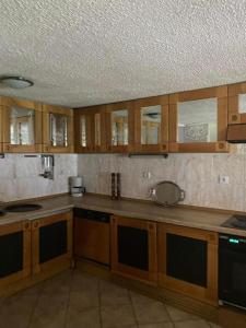 a kitchen with wooden cabinets and a counter top at Vintage villa in Paleo Tsifliki +23 photos