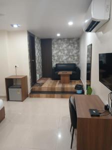 a living room with a couch and a table at Sarovar Hills Hotel and Resort in Jamshedpur