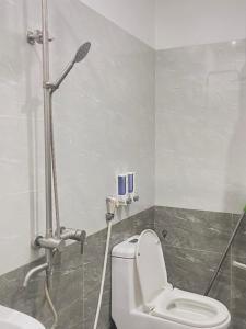 a bathroom with a toilet and a shower at Trà My 68 in Ðại Sơn +9 photos