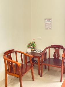 two wooden chairs and a table and a table and chairs at Trà My 68 in Ðại Sơn
