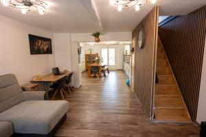 a living room with a staircase and a table and a couch at Chez Simon, au fil de l'eau in Revel +41 photos