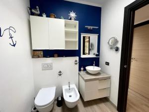 a bathroom with a white toilet and a sink at Casa Miralago - Cuasso al Monte in Cuasso Al Monte +11 photos