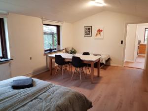 a dining room with a table and chairs in a room at Central Apartment in Billund - 500 m from LegoHouse in Billund