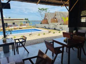 a restaurant with tables and chairs and a swimming pool at Seabreeze Haven Resort in Maria