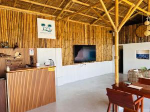 a room with a table and a tv on a wall at Seabreeze Haven Resort in Maria