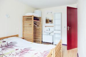 a bedroom with a bed and a sink at Les Gîtes du Bois de Chelles in La Chapelle-Geneste +7 photos