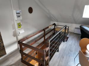 a set of stairs in a room with white walls at Appartement cosy en ville avec 2 places de parking privées intérieur in Beuvrages