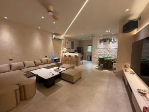 a living room with a couch and a table at Easy Stay Club in Xiaoliuqiu