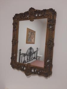 an ornate mirror hanging on a wall at B&B Borgo Antico in Taranto